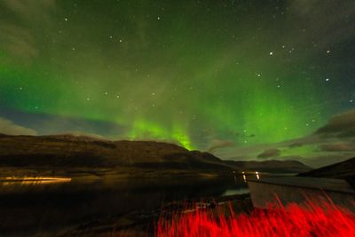 Scenic view of mountains against sky at night