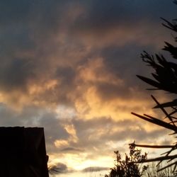 Low angle view of cloudy sky at sunset