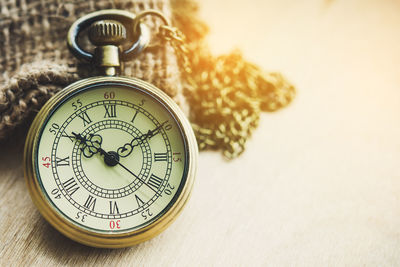 Close-up of pocket watch on table