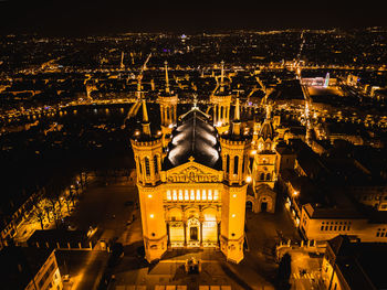 Panoramic aerial shot at night time of illuminated basilica notre dame de fourviere 