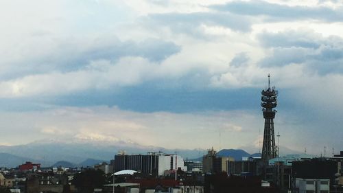 Buildings against cloudy sky