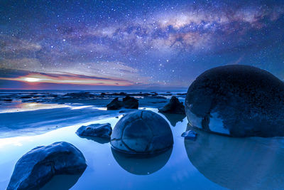 Panoramic view of sea against sky at night