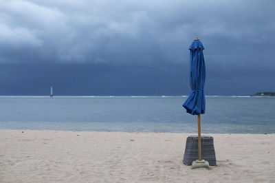 Lifeguard hut on beach against sky