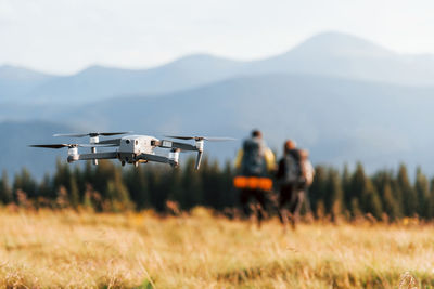 Drone on field against mountain