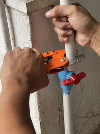 Close-up of man working on wall