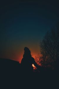 Silhouette man against sky during sunset