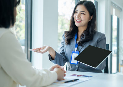 Young woman using digital tablet at office