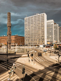 High angle view of city street and buildings against sky