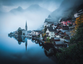 Residential district by river during foggy weather