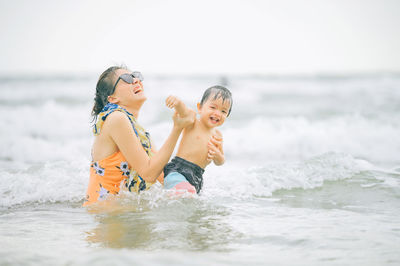 Portrait of young woman swimming in sea