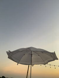 Low angle view of umbrella against clear sky