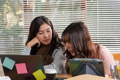 Young woman using laptop at office