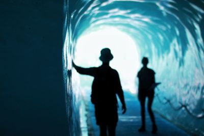 Silhouette men in aquarium