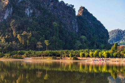 Camping at lake shore of nong thale lake and karst mountain at sunrise, krabi, thailand