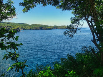 Scenic view of sea against blue sky