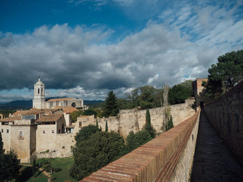 View of buildings against cloudy sky