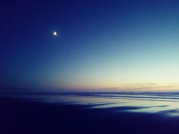 Scenic view of sea against clear sky at night