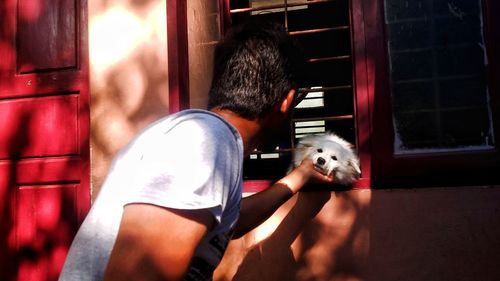 Midsection of man with dog