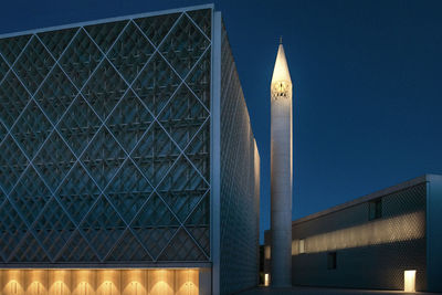 Low angle view of modern buildings against sky at night