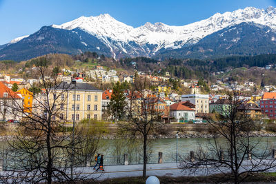 Panorama view of colorful buildings and mountains across from the river of innsbruck, austria