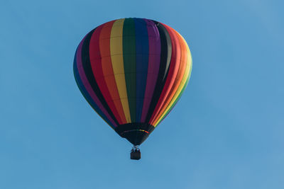 Low angle view of hot air balloon against blue sky