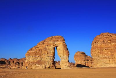 View of rock formation against clear blue sky