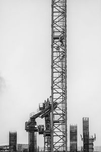 Low angle view of crane against sky