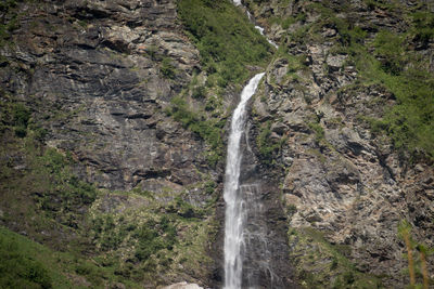 Scenic view of waterfall against sky