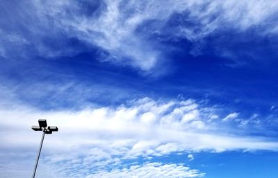 Low angle view of street light against blue sky