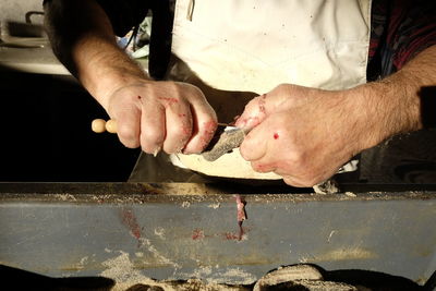 Midsection of man preparing food