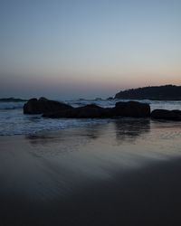 Scenic view of sea against clear sky during sunset