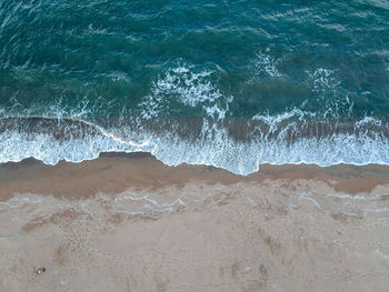 High angle view of waves on beach