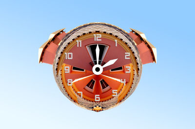 Low angle view of clock against clear blue sky