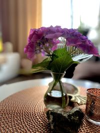 Close-up of purple flower vase on table at home