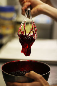Close-up of hand pouring water in bowl