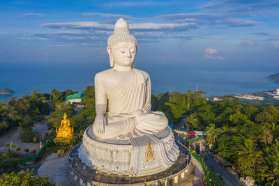 Statue of temple against cloudy sky