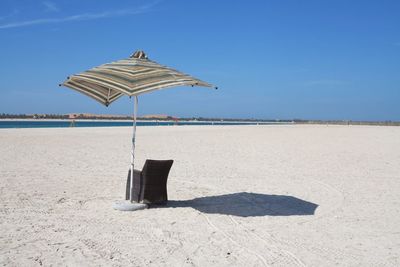 Scenic view of beach against blue sky