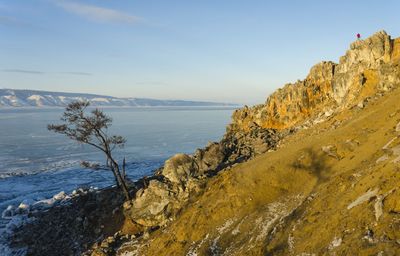 Scenic view of sea and mountains against sky