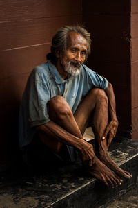 Young man sitting on sofa at home