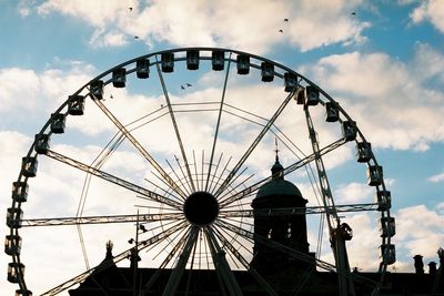 Low angle view of ferris wheel against sky