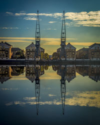 Reflection of buildings in lake during sunset