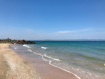 Scenic view of sea against blue sky