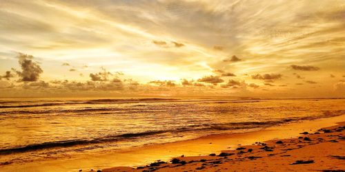 Scenic view of beach against sky during sunset