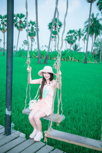 Full length of woman sitting on field