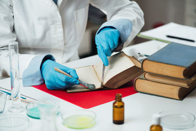 Antique book restoration. book restorer repairing damaged pages in an antique book