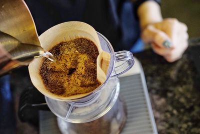 High angle view of barista making coffee in cafe