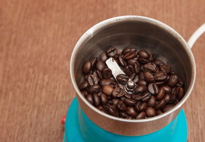 High angle view of coffee beans in bowl on table