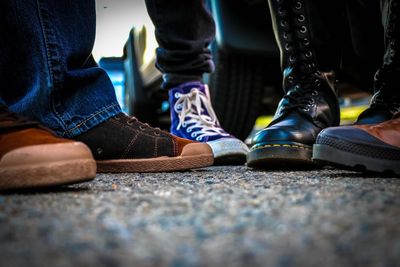 Low section of friends standing on road