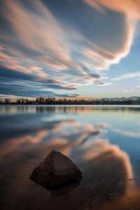 Scenic view of lake against sky at sunset