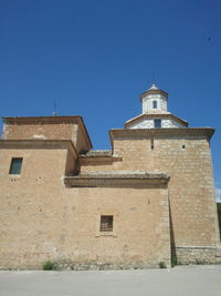 Exterior of historic building against clear blue sky